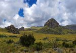 A gentle green plateau rising toward the rocky outcrop of Table Mountain across the high moorlands of Aberdare National Park.